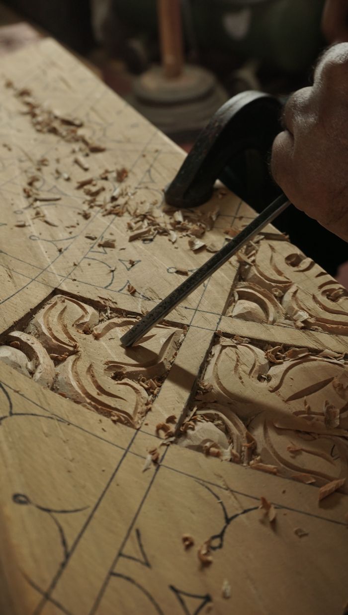 The Art of Drawing Readers In: Your attractive post title goes here Close-up of hand carving intricate designs on wood using chisels in Bengaluru workshop.